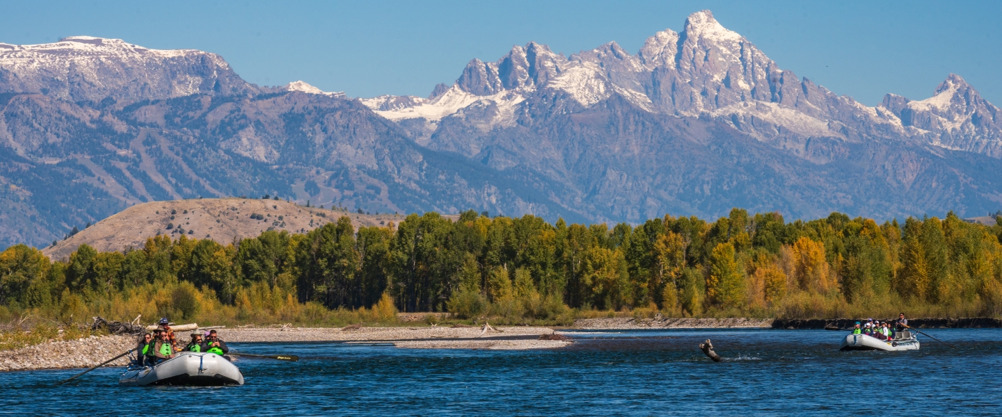 two rafts on a snake river scenic float with the Grand Tetons behind