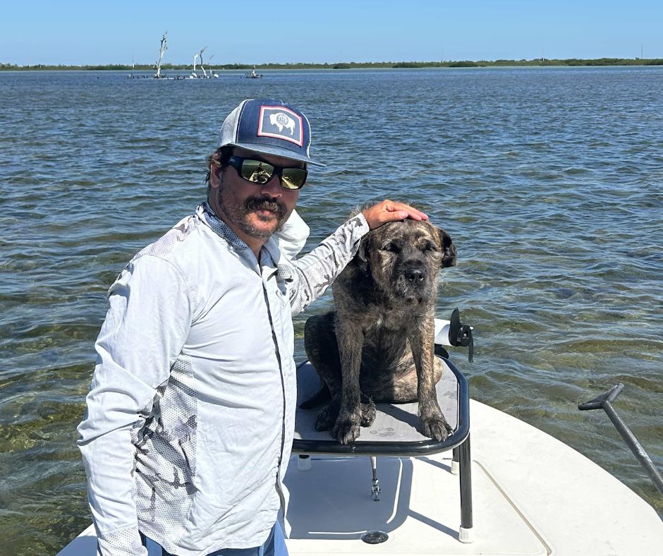 Marc Titre - Head Guide at Teton Scenic with his dog on a boat